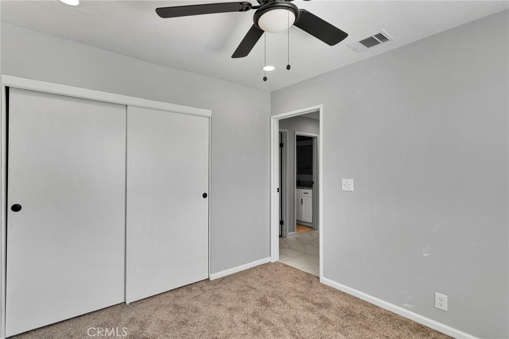 11076 Wagon Train Road Pinon Hills, CA 92371 - Photo 19 of 24 an empty room with chandelier fan
