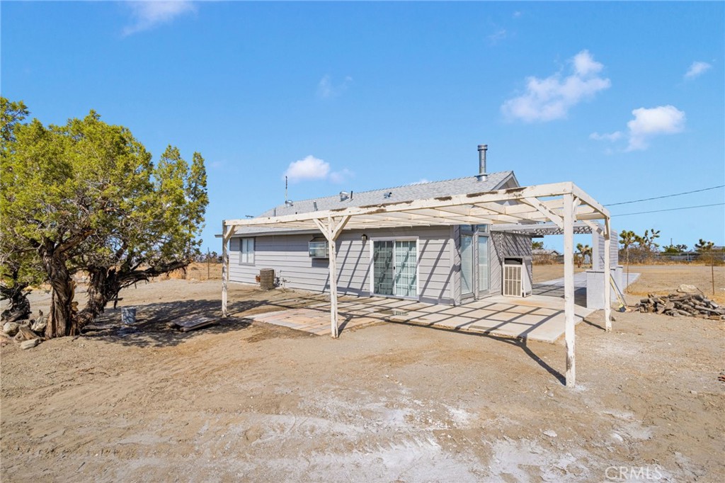 11076 Wagon Train Road Pinon Hills, CA 92371 - Photo 21 of 24 a view of a house with a yard and sitting area