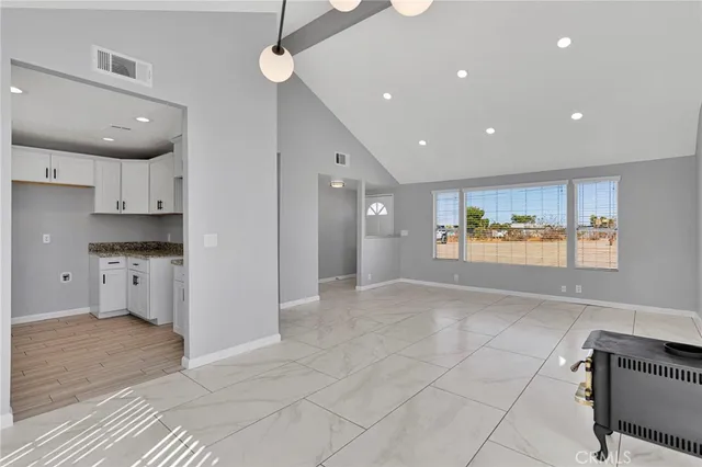 a view of kitchen with refrigerator and window