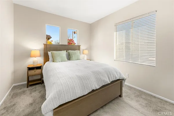 a bed sitting in a bedroom next to a window