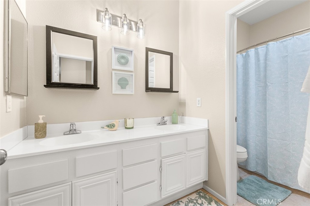 638 Sumner Way Oceanside, CA 92058 - Photo 12 of 17 a bathroom with a toilet sink and mirror
