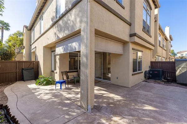 a view of a house with a small yard and wooden fence