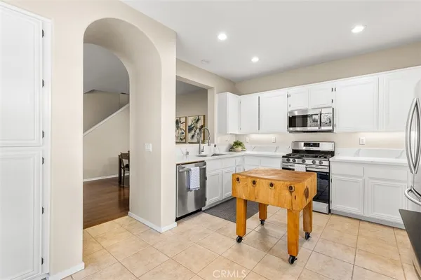 a kitchen with granite countertop cabinets and steel stainless steel appliances