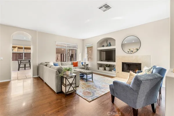a living room with furniture a fireplace and a flat screen tv