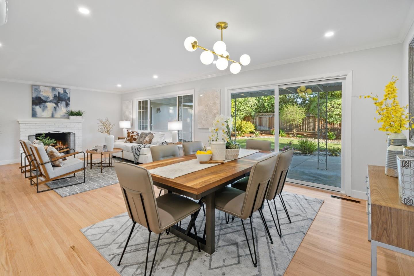 a view of a dining room with furniture a chandelier and wooden floor