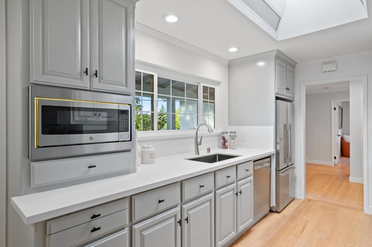 1720 Havenhurst Drive Los Altos, CA 94024 - Photo 8 of 49 a kitchen with stainless steel appliances granite countertop white cabinets and window