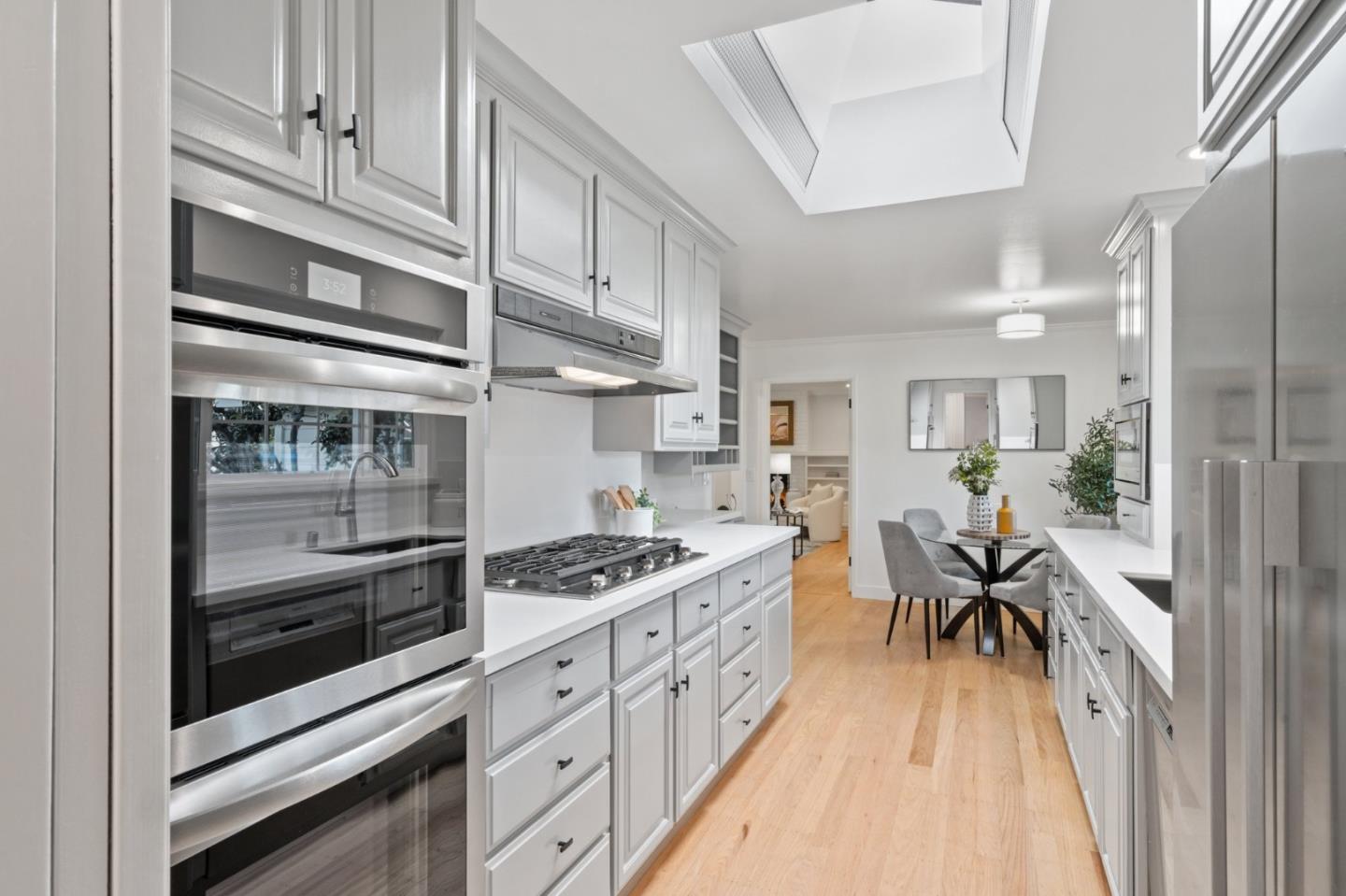 1720 Havenhurst Drive Los Altos, CA 94024 - Photo 9 of 49 a kitchen with stainless steel appliances kitchen island granite countertop a stove a refrigerator and white cabinets with wooden floor