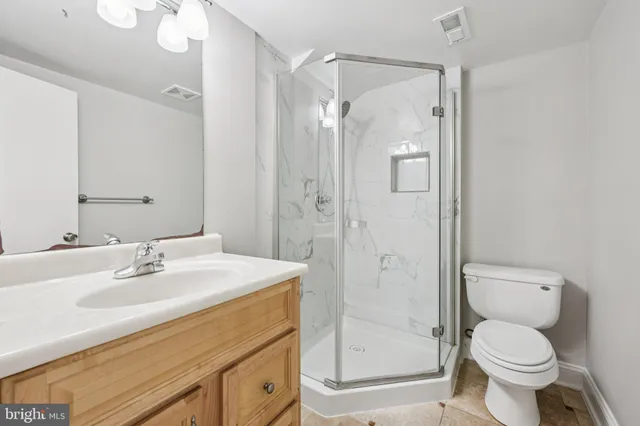 a view of a kitchen with white cabinets