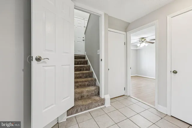 a view of a patio with table and chairs and wooden fence
