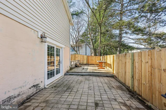 a roof deck view with table and chairs