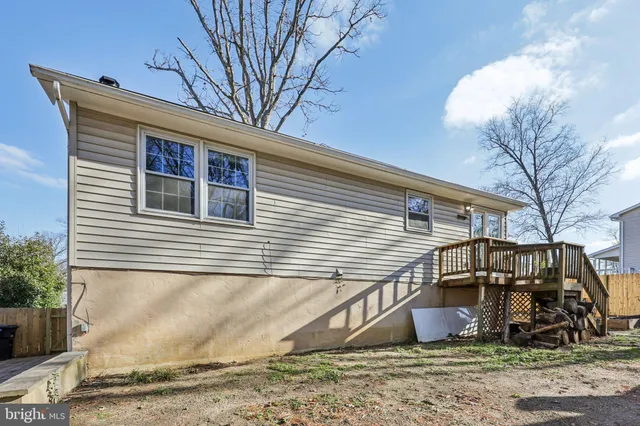 a view of a yard with wooden fence