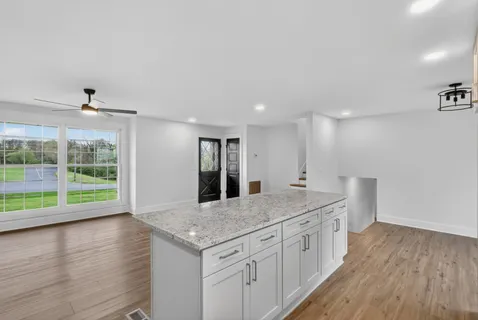 a kitchen with stainless steel appliances granite countertop a stove a sink and a refrigerator