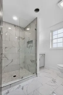a bathroom with a shower sink and mirror