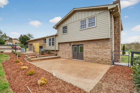 a view of a house with a yard and sitting area