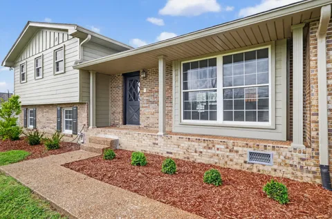 a view of kitchen with refrigerator stove and wooden floor