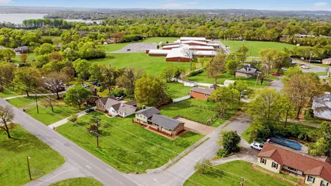 an aerial view of a house with garden space and street view