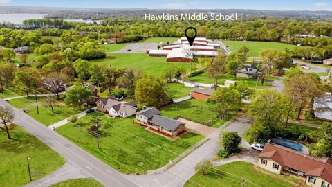 an aerial view of a house with a yard