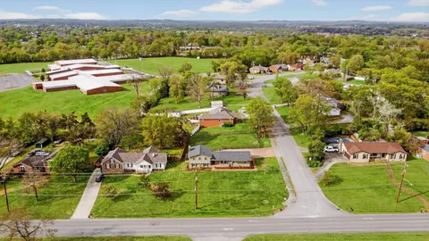 an aerial view of a house with garden space and street view