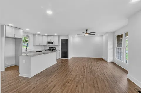 a view of kitchen with sink microwave and refrigerator