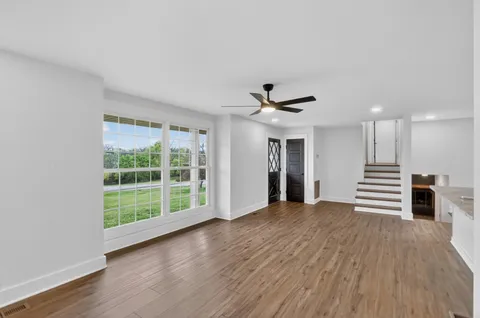 a kitchen with kitchen island granite countertop appliances cabinets a sink and a counter top space
