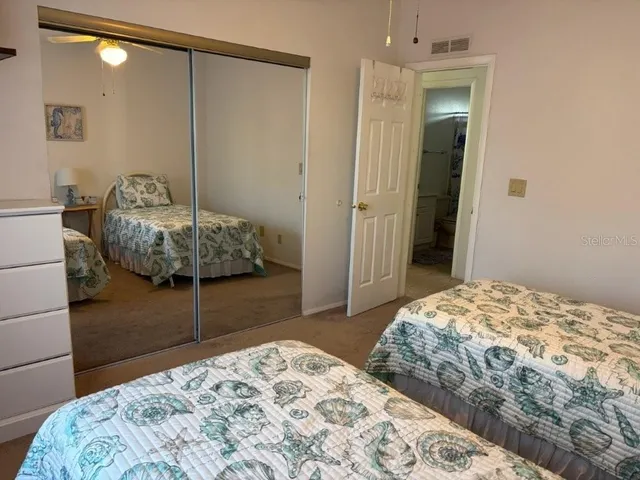 a bedroom with a bed and a mirror