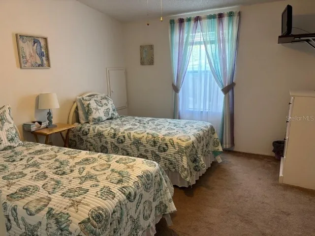 a bedroom with double bed and a window