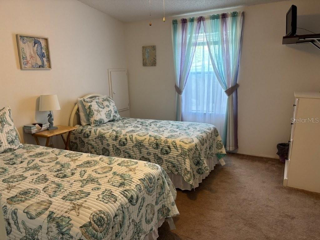 617 Webb Way Lady Lake, FL 32159 - Photo 8 of 15 a bedroom with double bed and a window