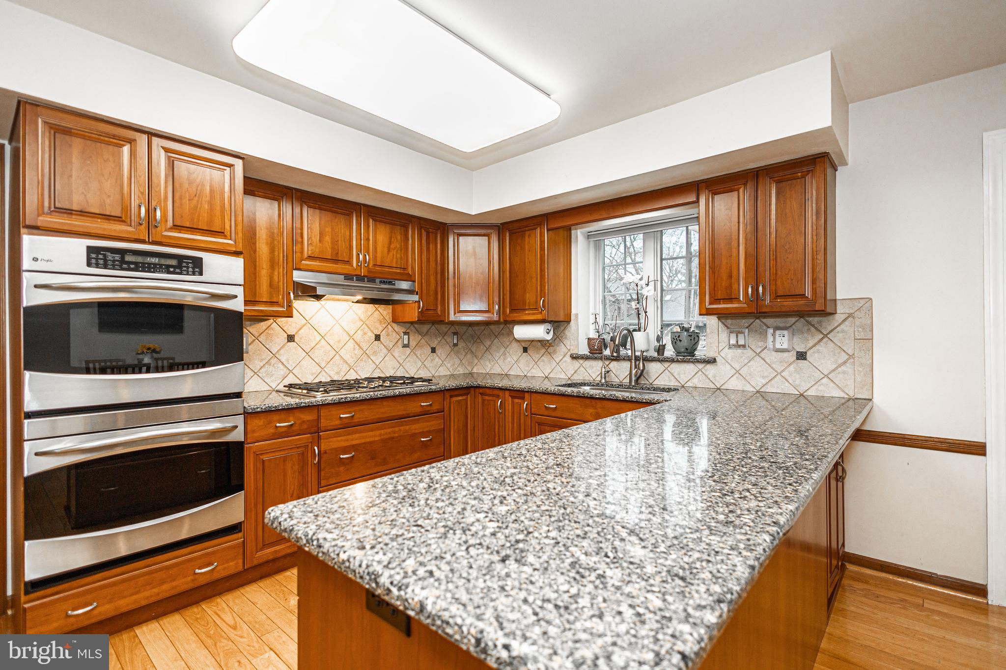 649 Teich Drive Yardley, PA 19067 - Photo 17 of 63 a kitchen with stainless steel appliances granite countertop a stove a sink and a microwave
