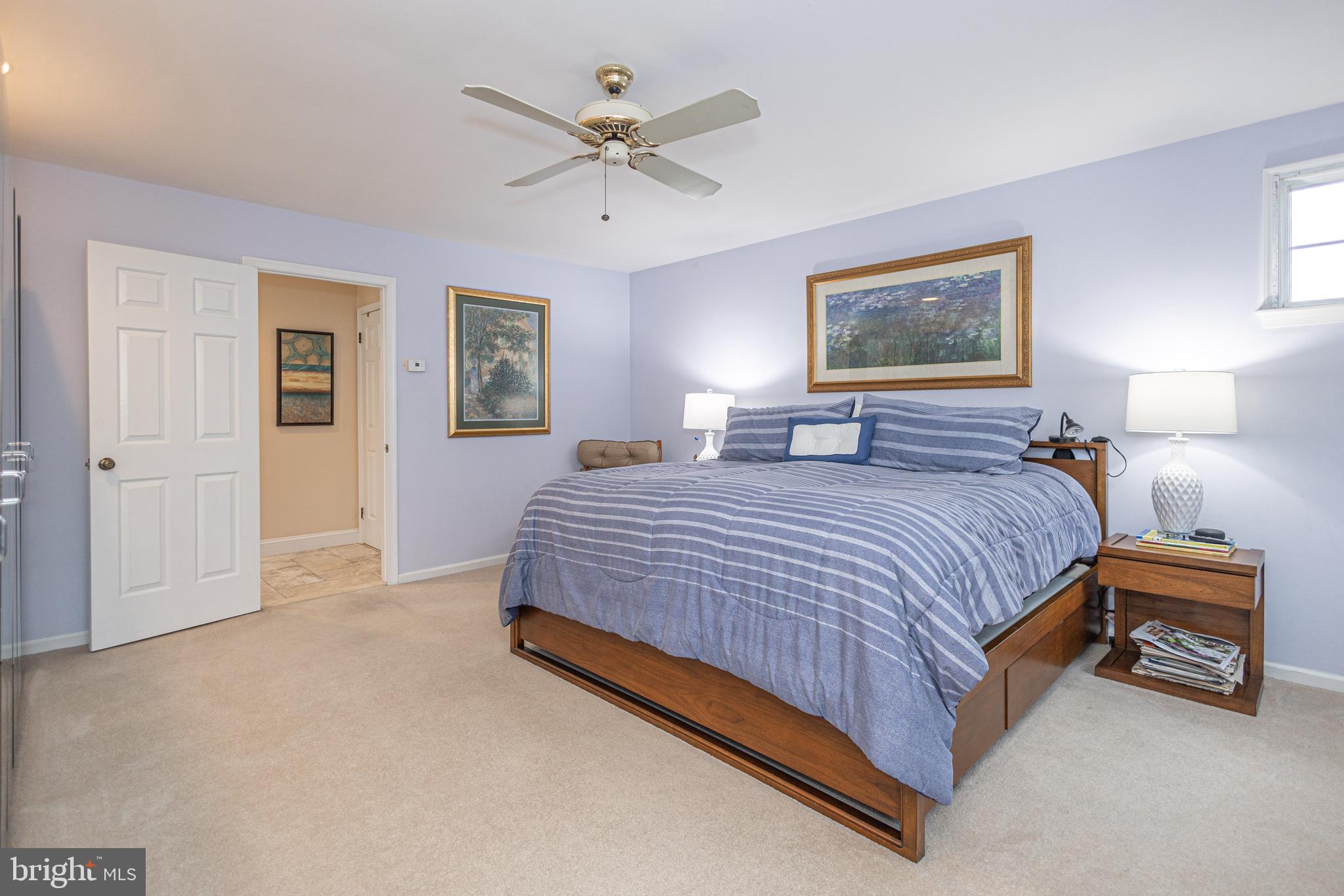 649 Teich Drive Yardley, PA 19067 - Photo 28 of 63 a spacious bedroom with a bed and a chandelier