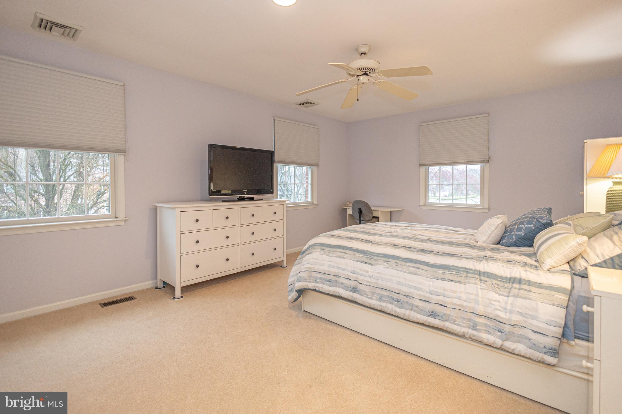649 Teich Drive Yardley, PA 19067 - Photo 34 of 63 a spacious bedroom with a bed and a flat screen tv