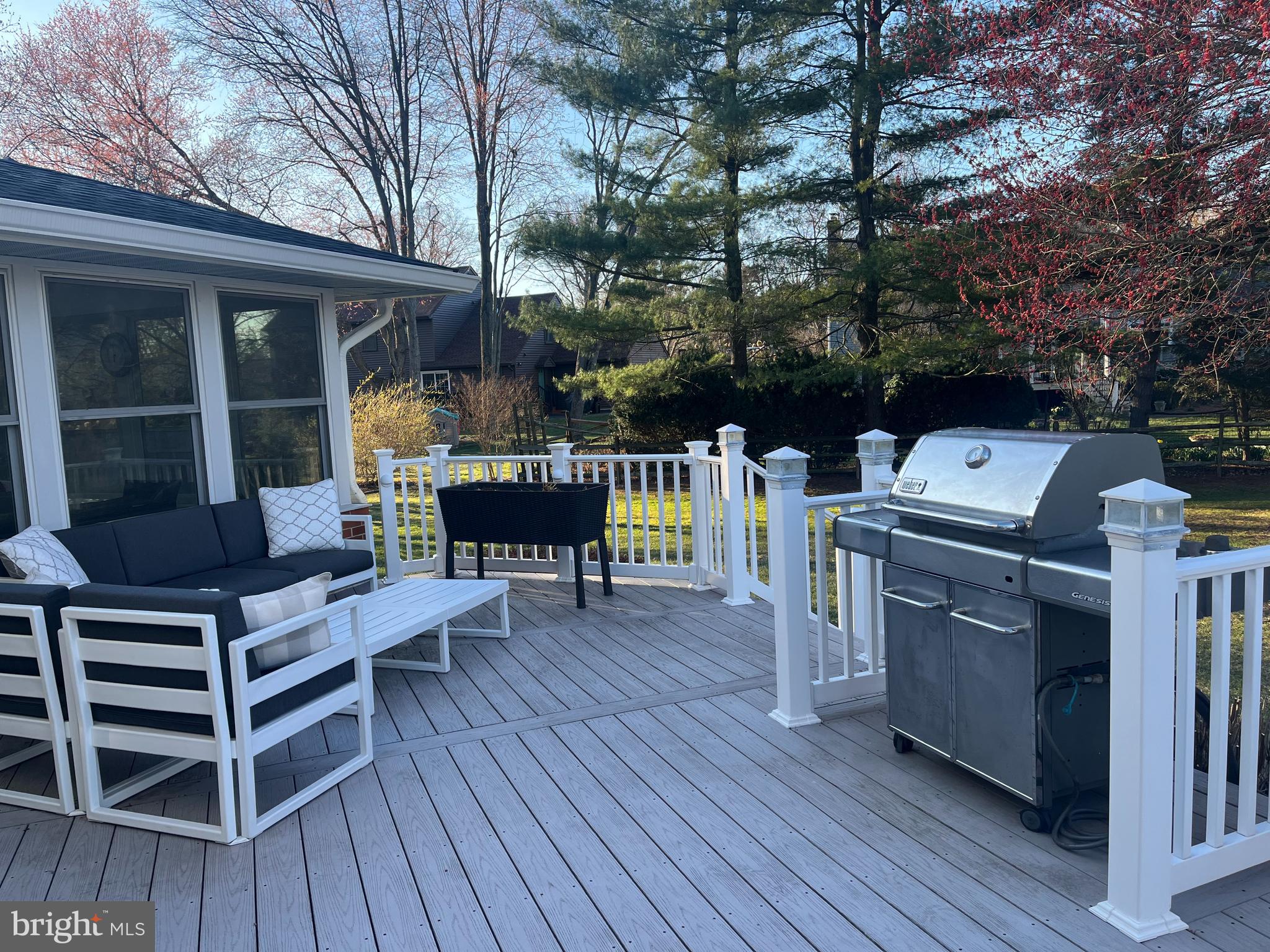 649 Teich Drive Yardley, PA 19067 - Photo 47 of 63 a view of a deck with table and chairs with wooden floor and fence