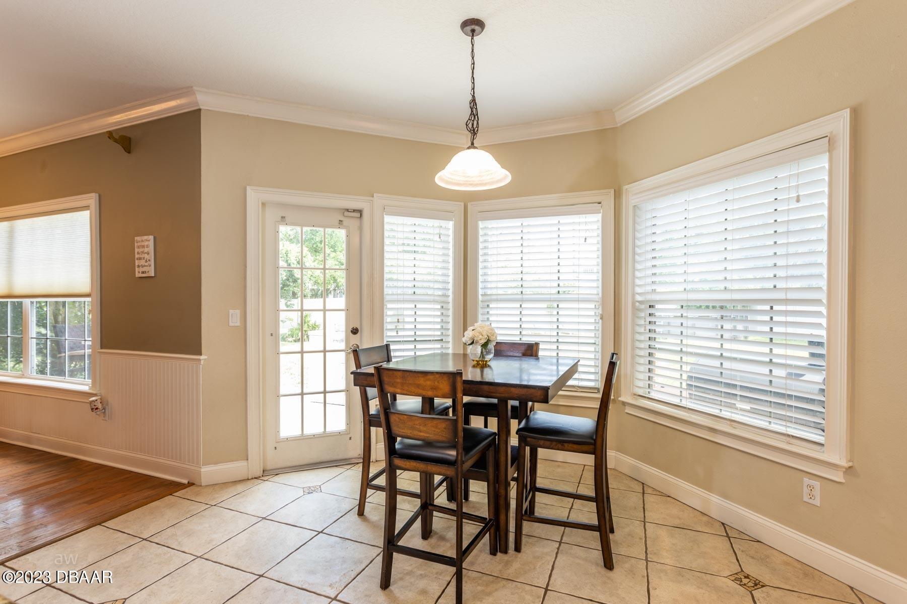 10 Foxhunter Flat Ormond Beach, FL 32174 - Photo 17 of 41 a dining room with furniture a chandelier and wooden floor