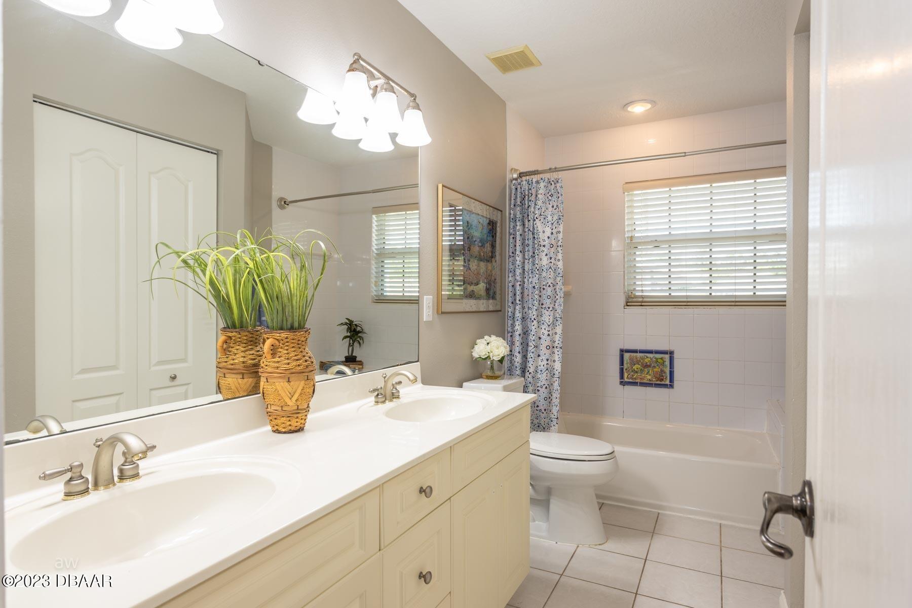 10 Foxhunter Flat Ormond Beach, FL 32174 - Photo 28 of 41 a bathroom with a granite countertop sink a toilet a mirror and shower