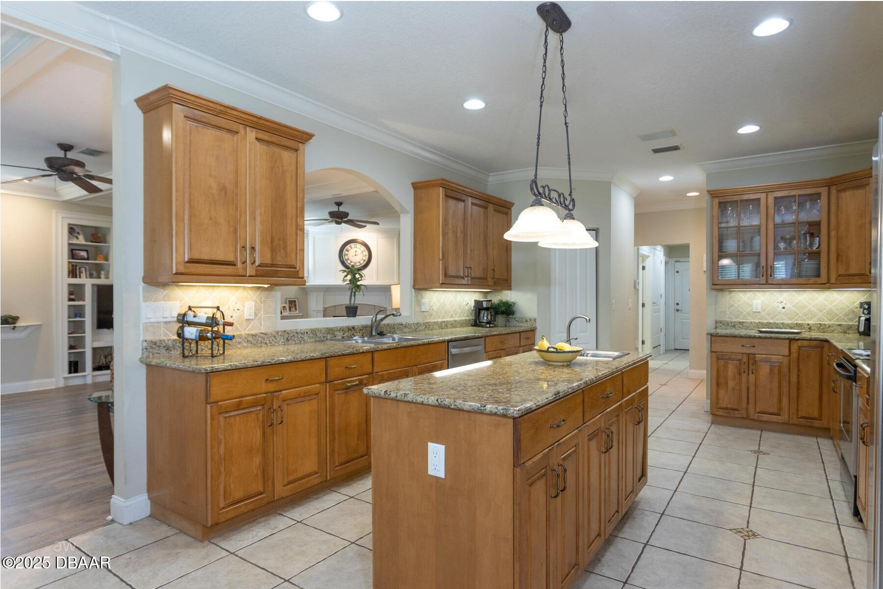 10 Foxhunter Flat Ormond Beach, FL 32174 - Photo 4 of 41 a kitchen with kitchen island granite countertop wooden cabinets and white appliances