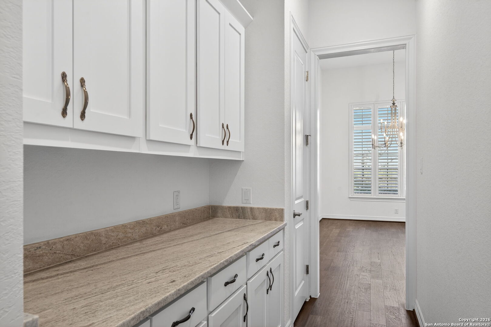 28640 Bull Gate Boerne, TX 78015 - Photo 17 of 40 a kitchen with granite countertop white cabinets and a wooden floor
