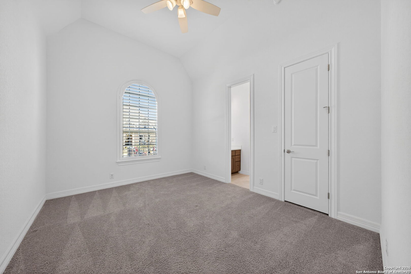 28640 Bull Gate Boerne, TX 78015 - Photo 28 of 40 an empty room with windows and chandelier fan