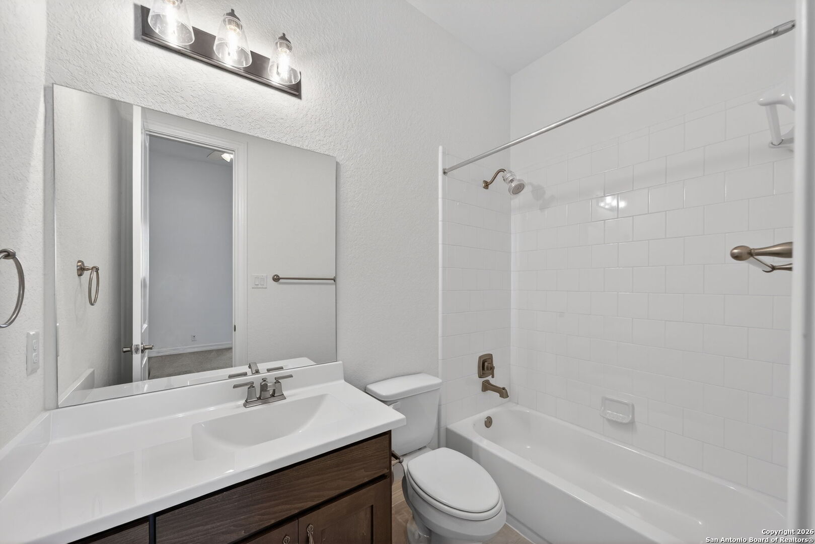28640 Bull Gate Boerne, TX 78015 - Photo 33 of 40 a bathroom with a granite countertop sink toilet a mirror and shower