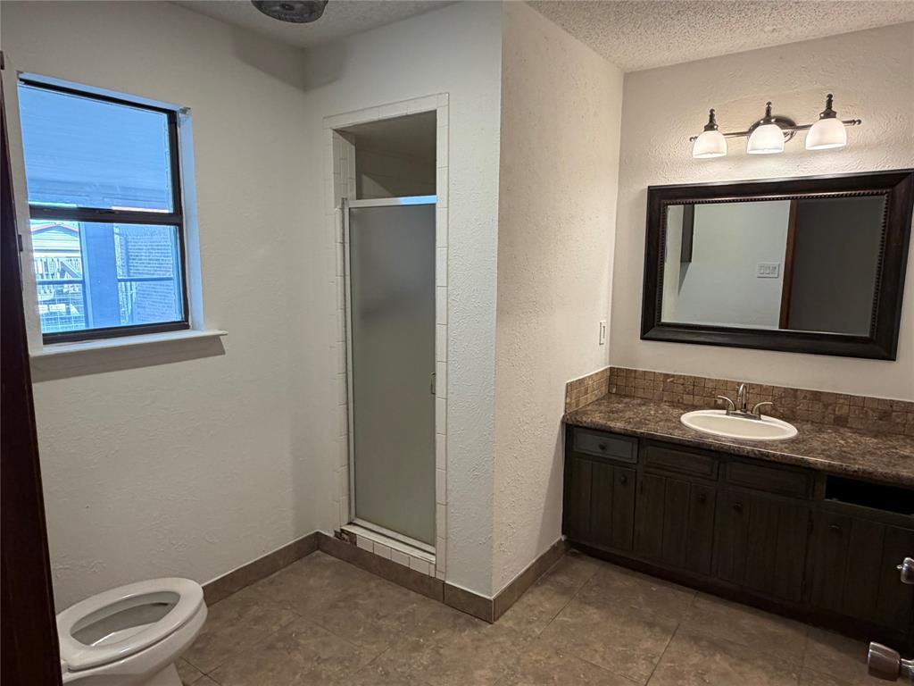 314 West 5th Street Springtown, TX 76082 - Photo 15 of 21 a bathroom with a toilet sink and mirror