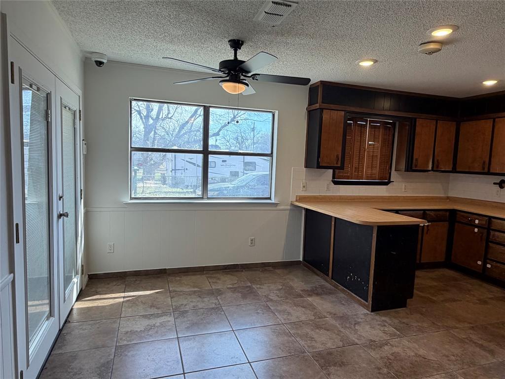 314 West 5th Street Springtown, TX 76082 - Photo 8 of 21 a kitchen with a stove window and cabinets
