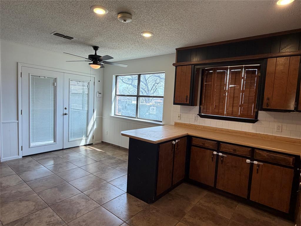 314 West 5th Street Springtown, TX 76082 - Photo 10 of 21 a kitchen with a refrigerator and a sink