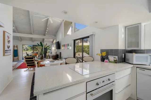 a kitchen with sink refrigerator and cabinets