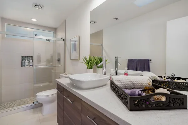 a bedroom with a bed and a potted plant