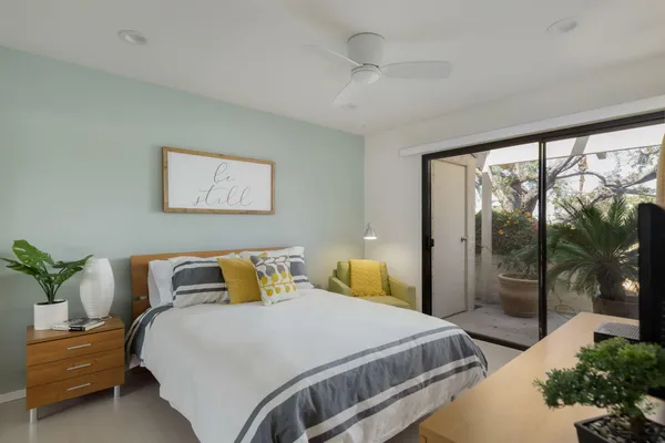 a bedroom with a bed and a large window