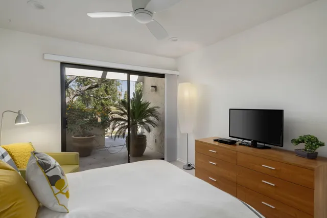 a bedroom with a bed and a flat screen tv