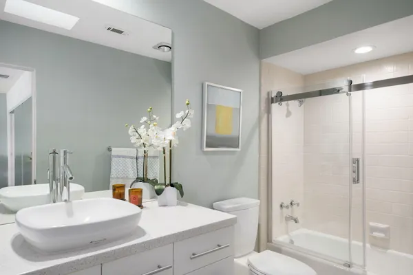 a bathroom with a sink toilet and shower