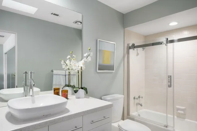 a bathroom with a sink toilet and shower