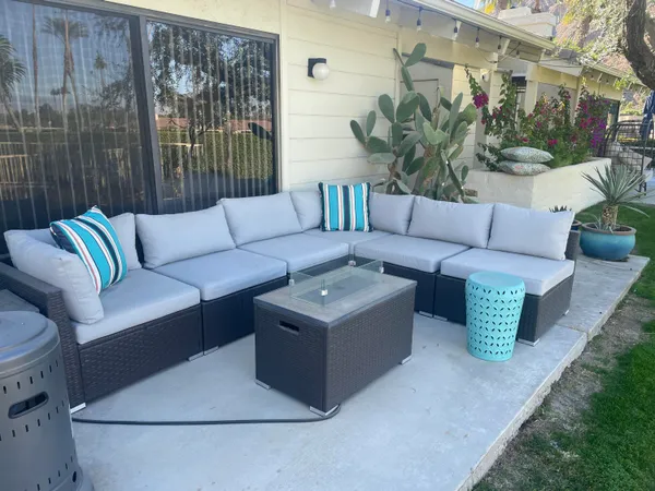a living room with furniture and a potted plant