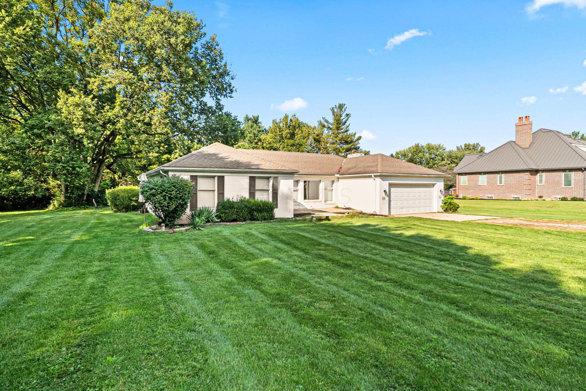 6344 Post Road Dublin, OH 43017 - Photo 4 of 45 Expansive front lawn with mature trees and established landscaping