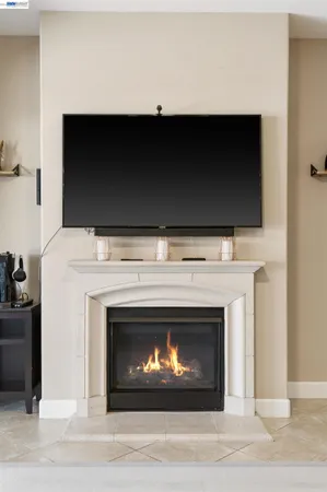 a kitchen with stainless steel appliances granite countertop a table chairs and a refrigerator