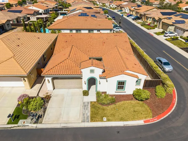 an aerial view of a house with a swimming pool